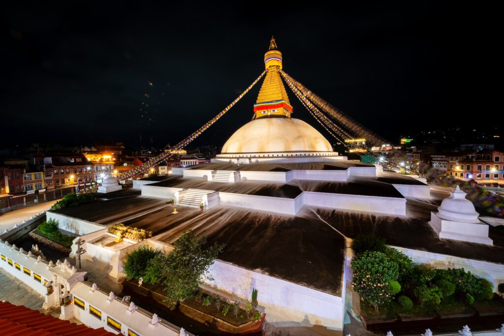 a large white building with a yellow roof at night