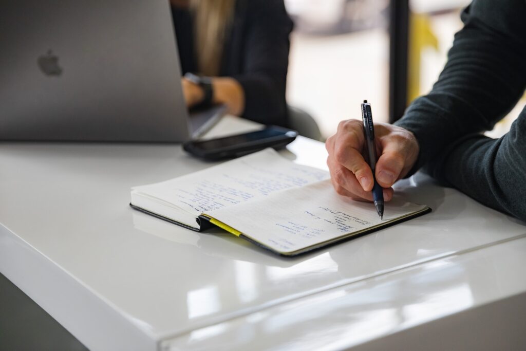 person writing on white paper